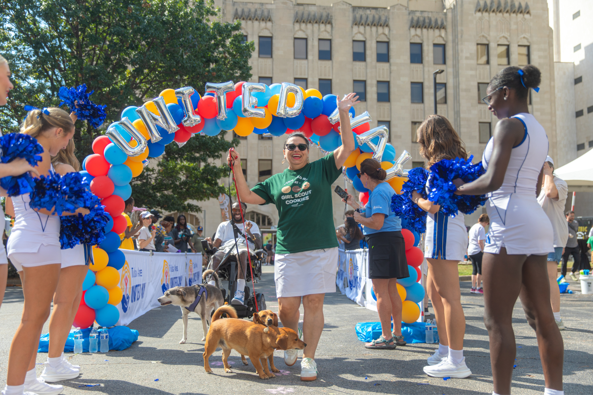 Downtown Deco Challenge event with people and balloon arch